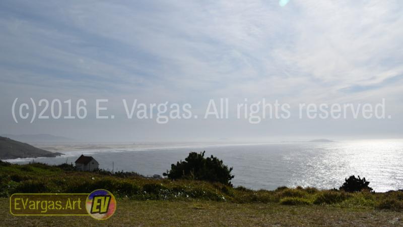 seacoast landscape seen from land, small church, daylight