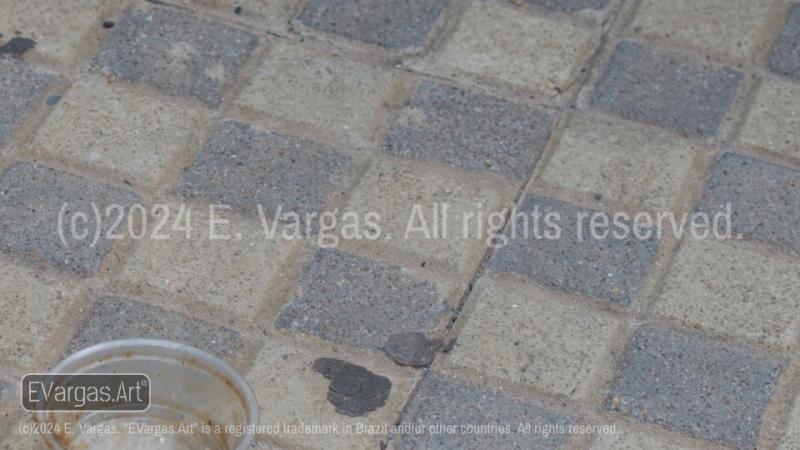 an empty plastic pot on a dirty sidewalk, daylight, urban, outdoors