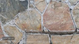 close-up of rocks on a wall, street, outdoors, daylight, zoom