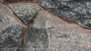 close-up of rocks on a wall, street, outdoors, daylight, zoom