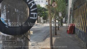 street, asphalt, old tire on concrete pole, street signs, street wall, traffic, urban, city, day, sunlight, outdoors